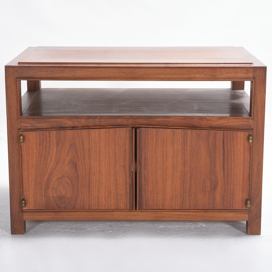 John Kapel Low Occasional Table with Cabinet.: John Kapel Low Occasional Table with Cabinet. The top with a shaped edge, over a storage space, above a two door cabinet. California. {Approximate dimensions: 21 1/2 high x 31 1/2 wide x 21 1/2 inches