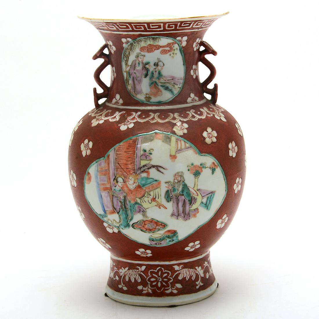 Famille Rose Orange Ground Vase.: Famille Rose Orange Ground Vase. The ovoid body raised on a tall splayed foot, sweeping up to a wide flared mouth, the waisted neck flanked by a pair of handles molded in the shape of a ruyi scepter, 