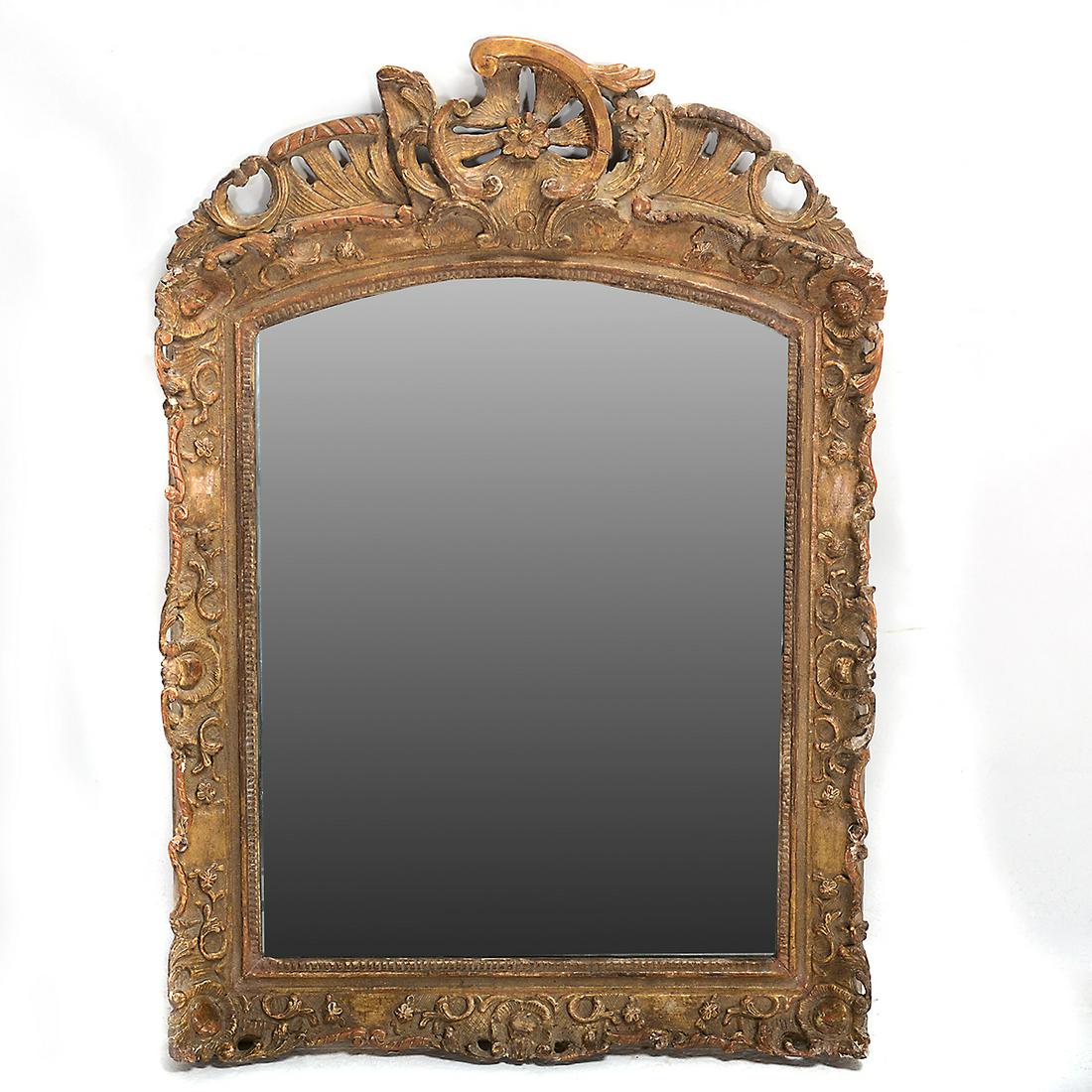 19th Century Rococo Style Carved Gilt-Wood Mirror.: 19th Century Rococo Style Carved Gilt-Wood Mirror. Mid 19th century. {Approximate dimensions: 40 1/2 high x 28 inches wide.}. Condition: Minor loss to the carving, patina and rubbing to the gilt.
