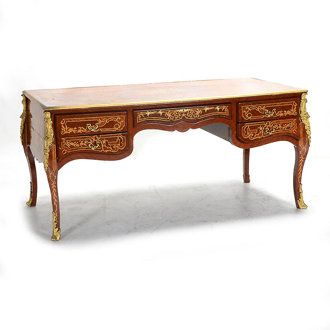 Italian Louis XV Style Marquetry Desk with Ormolu: Italian Louis XV Style Marquetry Desk with Ormolu Mounts. Marquetry inlay throughout; the desk with one central drawer flanked by two drawers to either side. {Approximate dimensions: 32 1/4 high x 69 
