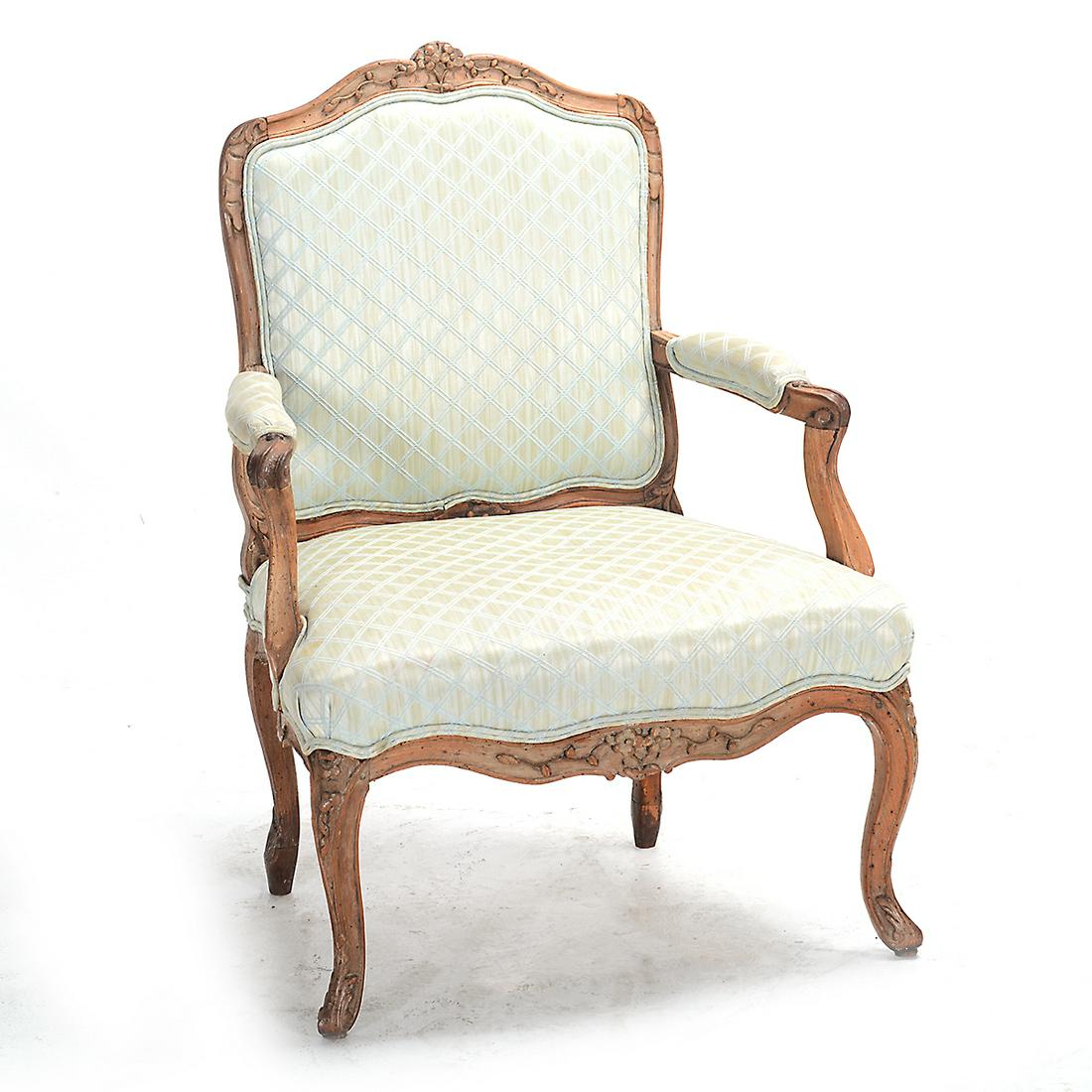 Louis XV Bergere.: Louis XV Bergere. Floral carved crown and seat rails; scroll carved arms and feet; pale green and silver upholstery. 18th century. {Approximate dimensions: 39 high x 28 wide x 25 inches deep.}. Condit