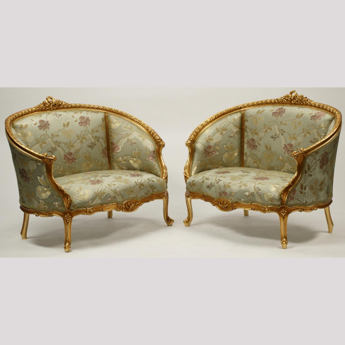 Pair of Louis XV Style Carved Gilt-Wood Settees.: Pair of Louis XV Style Carved Gilt-Wood Settees. With light blue floral decorated upholstery. {Approximate dimensions: 37 high x 48 wide x 29 inches deep.}. Condition: Very light wear, slight patina t