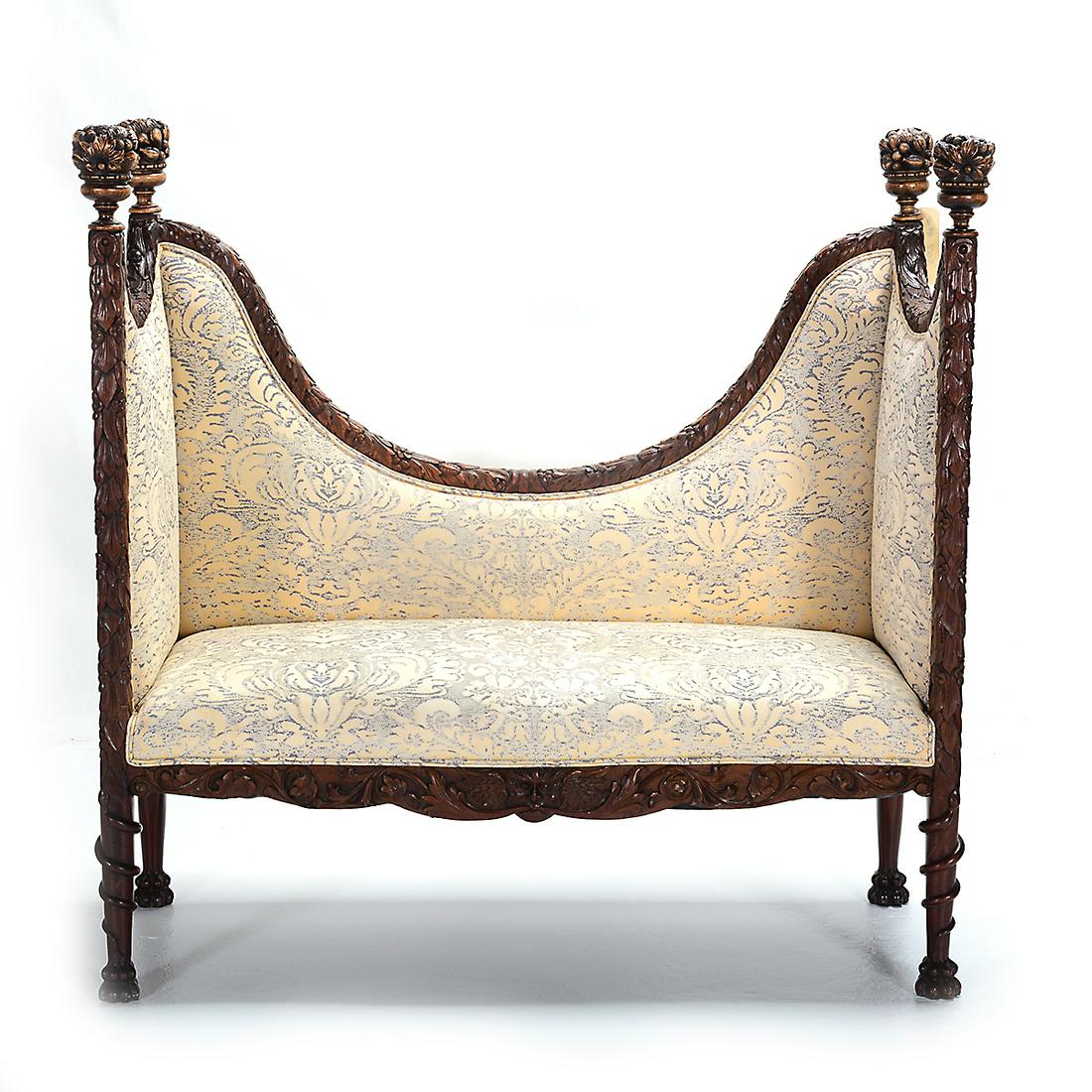 19th Century Victorian Mahogany Settee Covered Voided: 19th Century Victorian Mahogany Settee Covered Voided Velvet by Scalamandre. The frame extensively carved with a floral and foliate motif, accented with fruit filled urn finials, supported by snake-wr