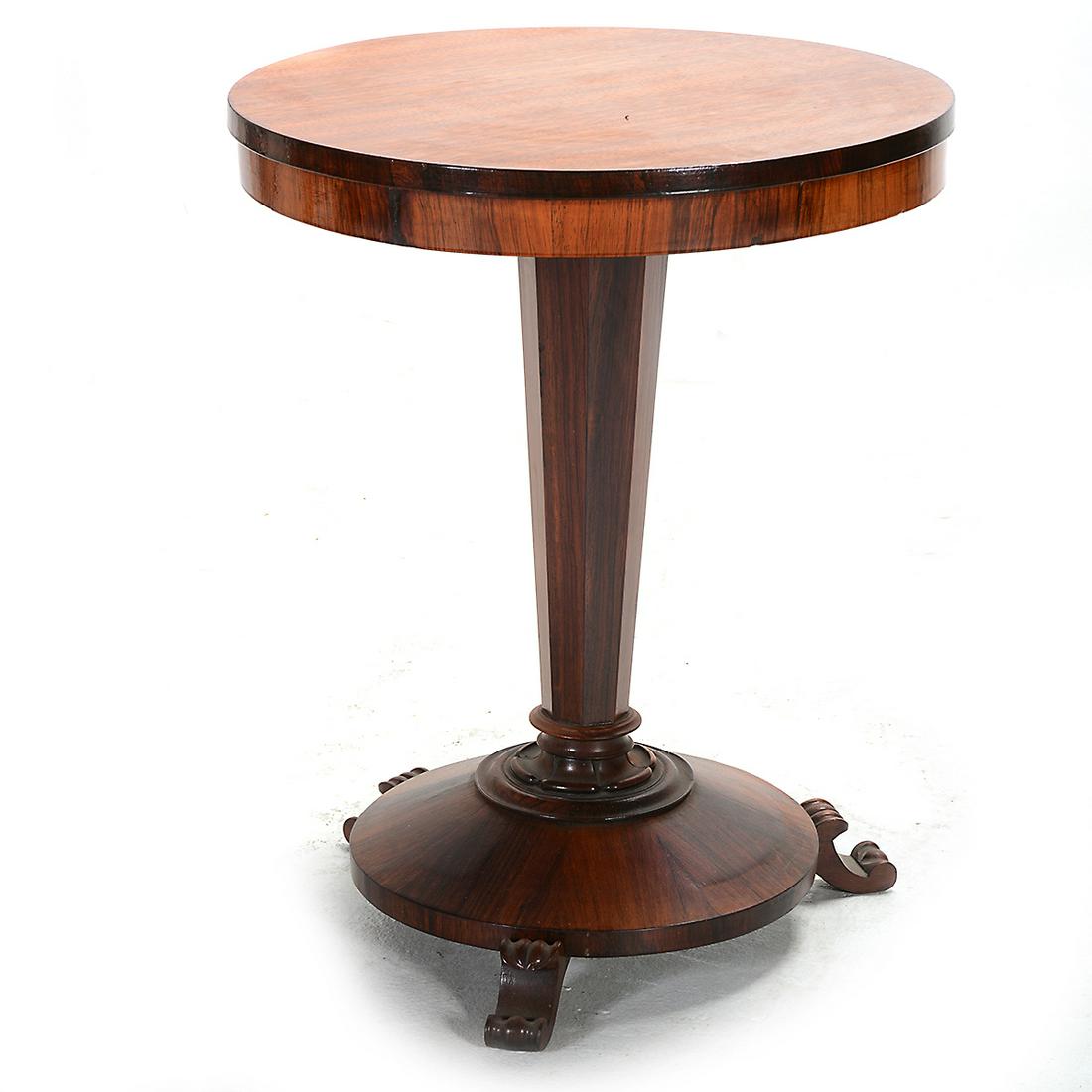 English Victorian Rosewood* Round Pedestal Table.: English Victorian Rosewood* Round Pedestal Table. Round top on a octagonal pedestal; the tapered round base with three scrolled feet. Evidence of an antique label to the tops underside, mostly scratch