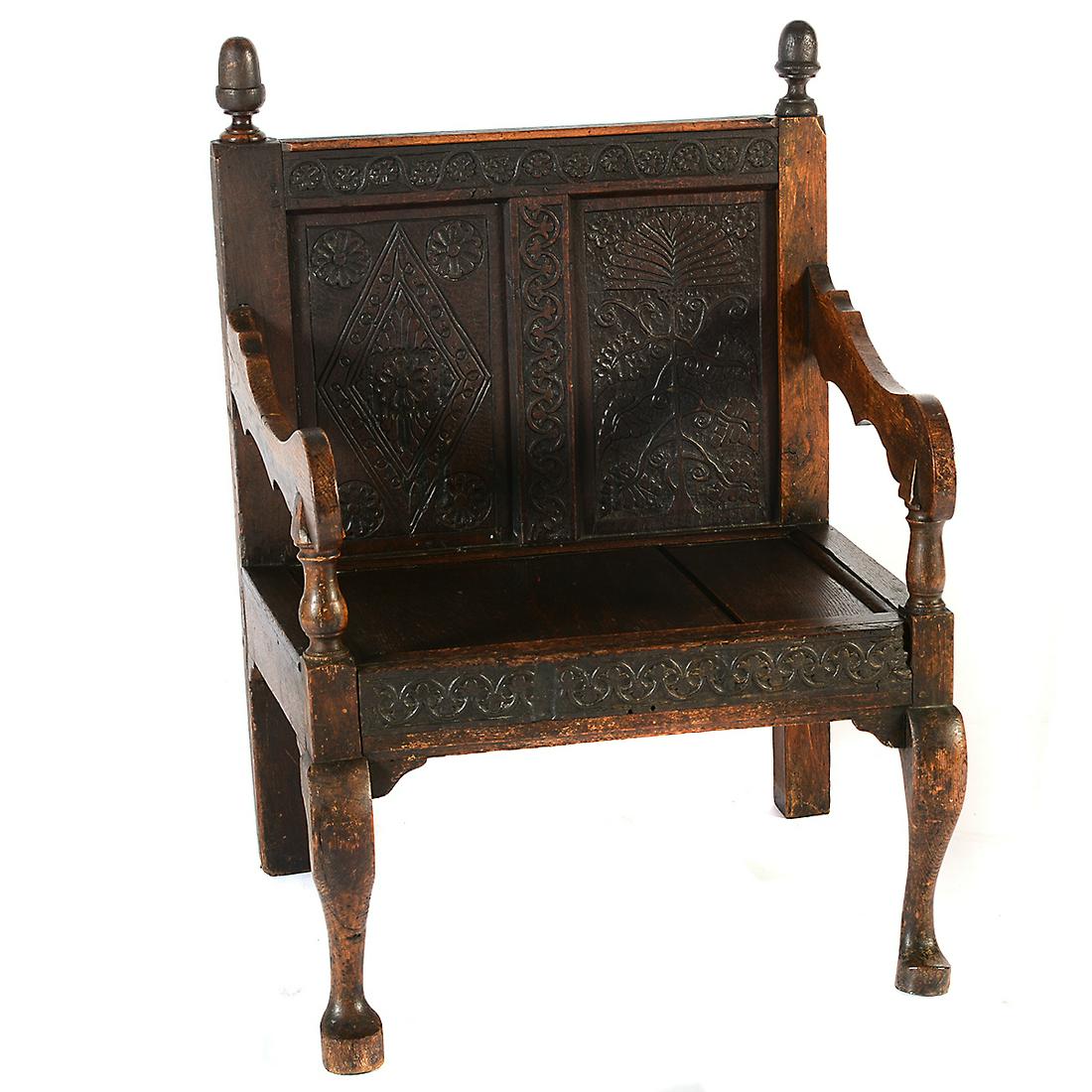 18th Century English Carved Oak Armchair.: 18th Century English Carved Oak Armchair. Two mismatched finials to the crown rail; the crown rail with carved rosettes; the two back panels with different carvings, tree of life and rosette within a 
