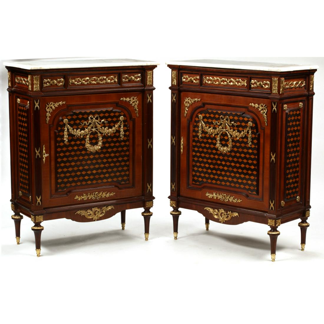 Pair of Louis XVI Style Inlaid Cabinets.: Pair of Louis XVI Style Inlaid Cabinets. Gilt bronze mounts; white marble tops. {Approximate dimensions: 44 1/2 high x 33 1/2 wide x 16 inches deep.}. Condition: Light wear overall. Key available.