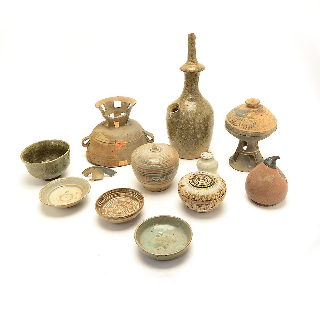 Group of Eleven Korean Pottery Items.: Group of Eleven Korean Pottery Items. Including three rounded dishes, two lidded jars, two unglazed vessels, a deep rounded bowl, a small ink pot with a cover, a vase with a spout, and a peach-shaped 