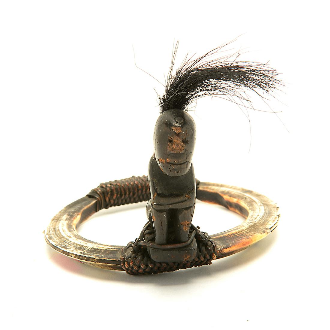 19th Century Ifugao Head Hunter Warriors Tongkil Boar: 19th Century Ifugao Head Hunter Warriors Tongkil Boar Tusk Bracelet with Bulul Figure. Rattan lash mounted on boar Tusks; seated wood Bulul figure carrying a rattan backpack filled with boar bristles.