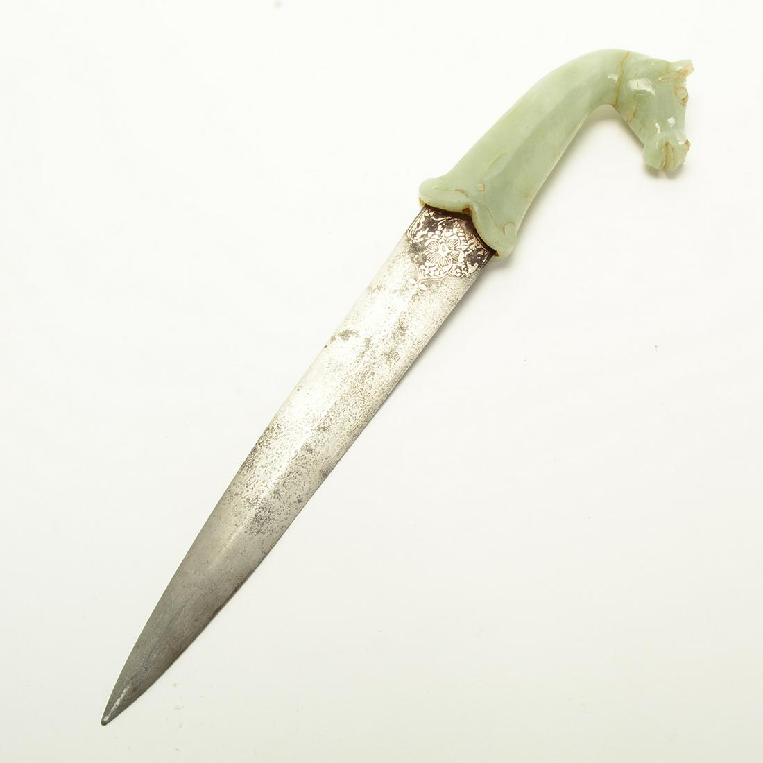 A Chinese Mughal Style Dagger Carved Hardstone Horse: A Chinese Mughal Style Dagger Carved Hardstone Horse Head Handle. The Blade cast with a subtle median ridge, the hilt carved in the form of a horse head with undercut teeth, the stone of pale green to