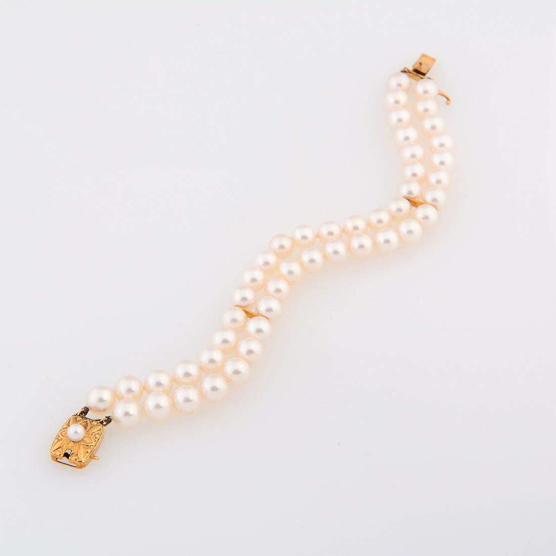 Mikimoto Cultured Pearl, 18k Yellow Gold Bracelet.: Mikimoto Cultured Pearl, 18k Yellow Gold Bracelet. Composed of forty-six round cultured pearls measuring approximately 6.9 mm to 6.6 mm, completed by a cultured pearl, 18k yellow gold clasp with figur