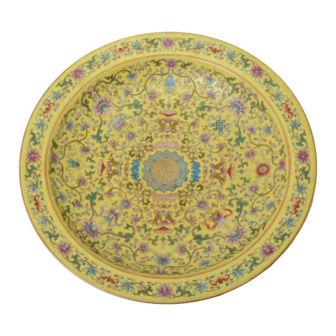 Chinese Large Yellow-Ground Famille Rose Charger.: Chinese Large Yellow-Ground Famille Rose Charger. The interior with a central medallion encircled by the Eight Buddhist Emblems amongst floral sprays, the exterior enameled with three leafy lotus spra