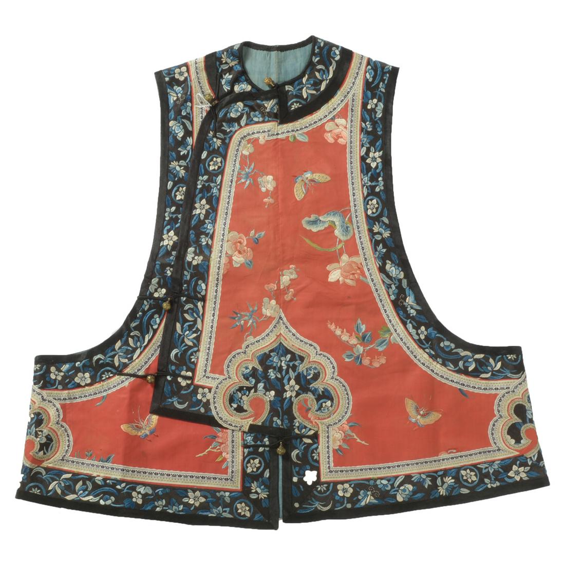 Set of Two Red-Ground Silk Vest and Skirt.: A Red-Ground Silk Vest and Skirt. The vest embroidered on a red silk ground with butterflies in flight amidst various flowers including lotus, peony and prunus, encircled by a black-ground ruyi-shaped