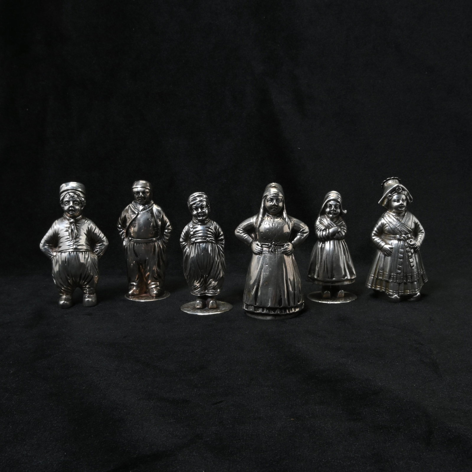 Continental .800 Silver Figural Novelty Shakers.: Continental .800 Silver Figural Novelty Shakers. Six rural men and women in various poses. Male and female pair marked with Dutch Minerva head mark with 'M'; robed male marked with 'HOLLAND, key, lion