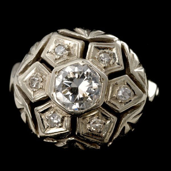 DIAMOND, 10K WHITE GOLD RING.: DIAMOND, 10K WHITE GOLD RING. Centering one full-cut diamond weighing approximately 0.55ct, surrounded by six single-cut diamonds weighing a total of approximately 0.05ct, bead set in a 10k white gold