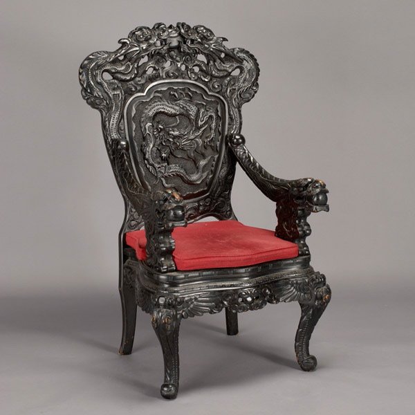 Chinese Carved Rosewood Dragon Chair, 20th Century: Chinese Carved Rosewood Dragon Armchair, 20th Century. Black lacquered wood with high back and elaborately carved dragon designs and patterns throughout, fitted red cushion. {Dimensions 52 1/2 x 31 x 