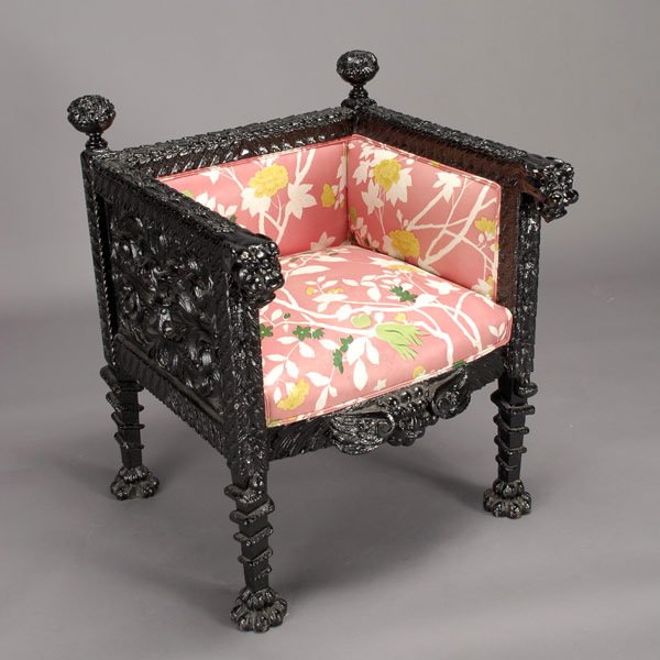 Chinese Carved Wood Club Chair, Late 20th Century: Chinese Carved Wood Club Chair, Late 20th Century. Square shape with ornate floral scroll pattern, spherical flower finials, lion head arms, coiled serpent legs, punk floral upholstery. {Dimensions 33