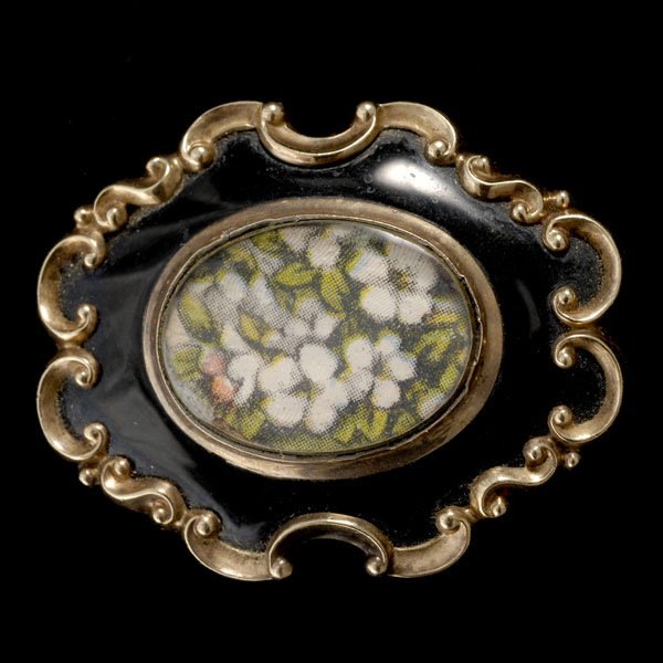 VICTORIAN ENAMEL, 9K YELLOW GOLD BROOCH.: VICTORIAN ENAMEL, 9K YELLOW GOLD BROOCH. Centering a locket compartment, accented by black enamel, set in a 9k yellow gold mounting, completed by a pin stem and catch. 7.6 dwts. Note: Not original par