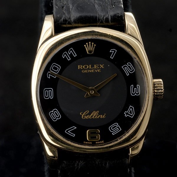 LADIES ROLEX 18K YELLOW GOLD, LEATHER WRISTWATCH: LADIES ROLEX CELLINI 18K YELLOW GOLD, LEATHER WRISTWATCH. Dial: Two-tone black, round, white outlined Arabic numeral hour markers, gold baton hands, Rolex Cellini. Movement: 8 Jewel, quartz, Montres R