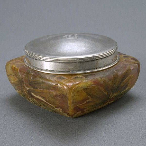 Daum Nancy Silver Mounted Dresser Box: Daum Nancy Silver Mounted Dresser Box, Early 20th Century, the paneled compressed ovoid jar with a collared rim, the claret and clear glass with amber and green overlay, side panel acid cut with spray