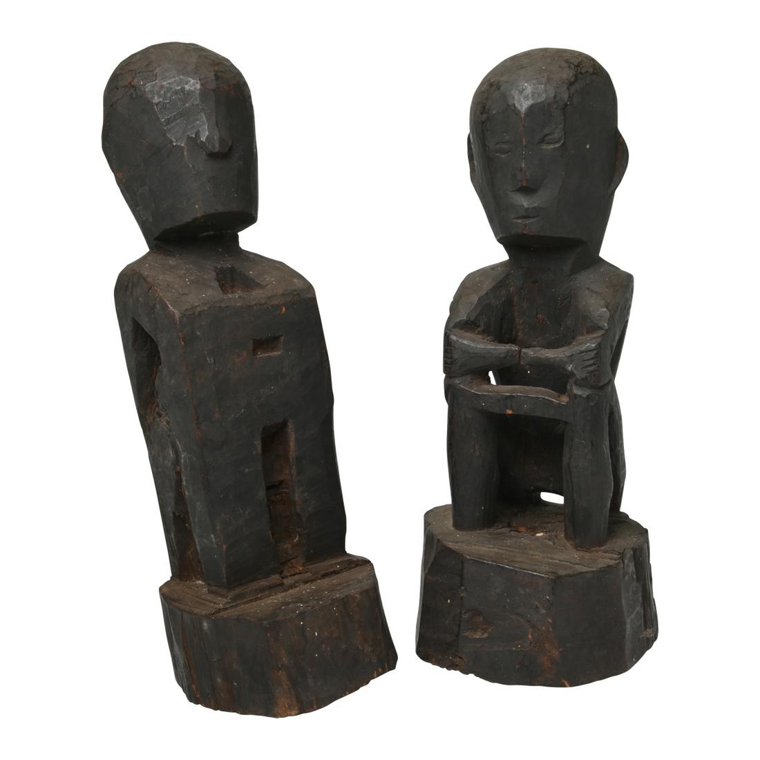 19th Century Ifugao Bulul Pair Male and Female Seated: 19th Century Ifugao Bulul Pair Male and Female Seated Statues. Two crouching figures with dark patina; one carved in full, the other is more of a block form. Catalogue stickers '652A'. Circa 1820. {Ap