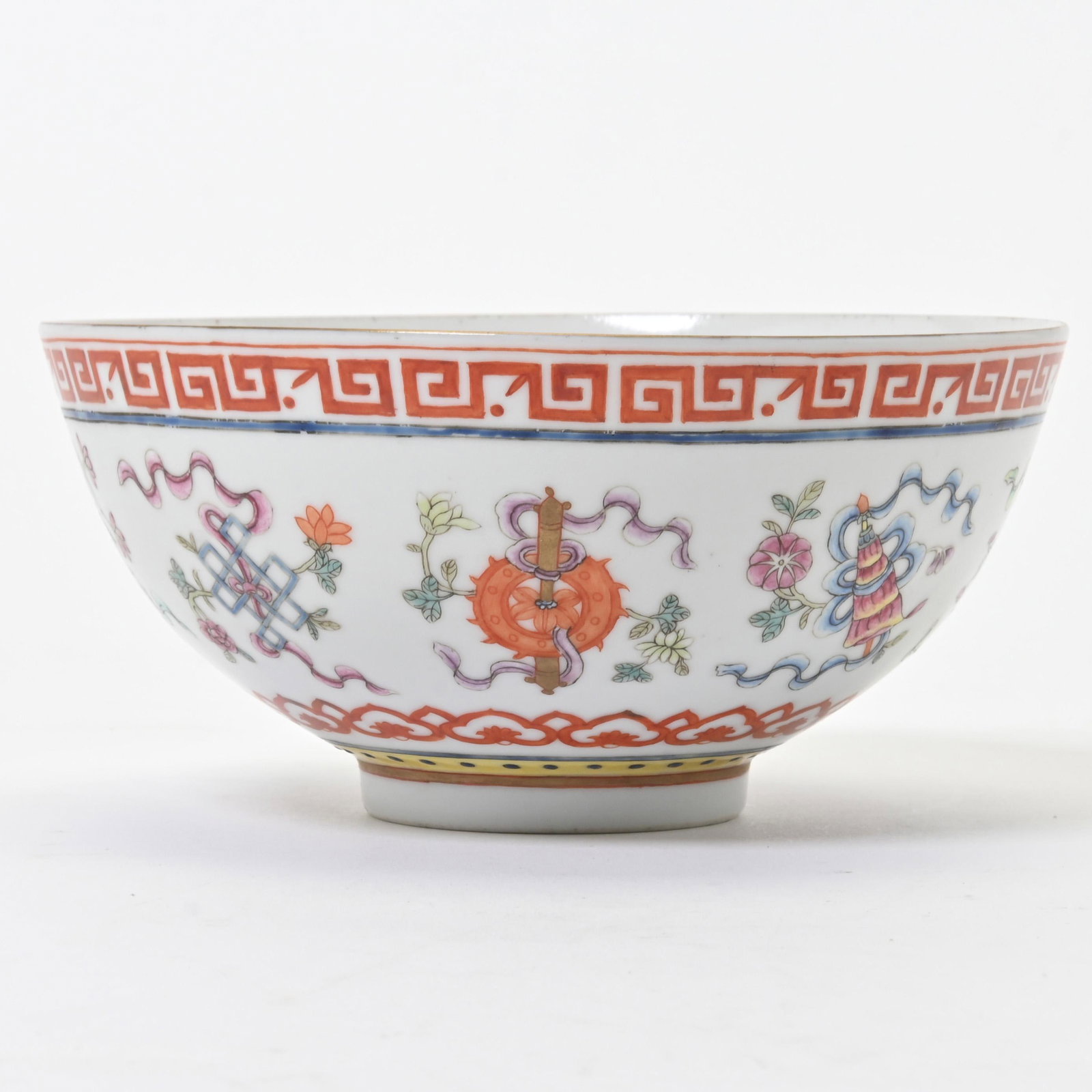 A Chinese Famille Rose 'Eight Treasures' Bowl: A Chinese Famille Rose 'Eight Buddhist Treasures' Bowl. The exterior walls embellished with the Eight Buddhist Emblems above a band of ruyi heads, a key-fret border on the mouth, with a six-character 