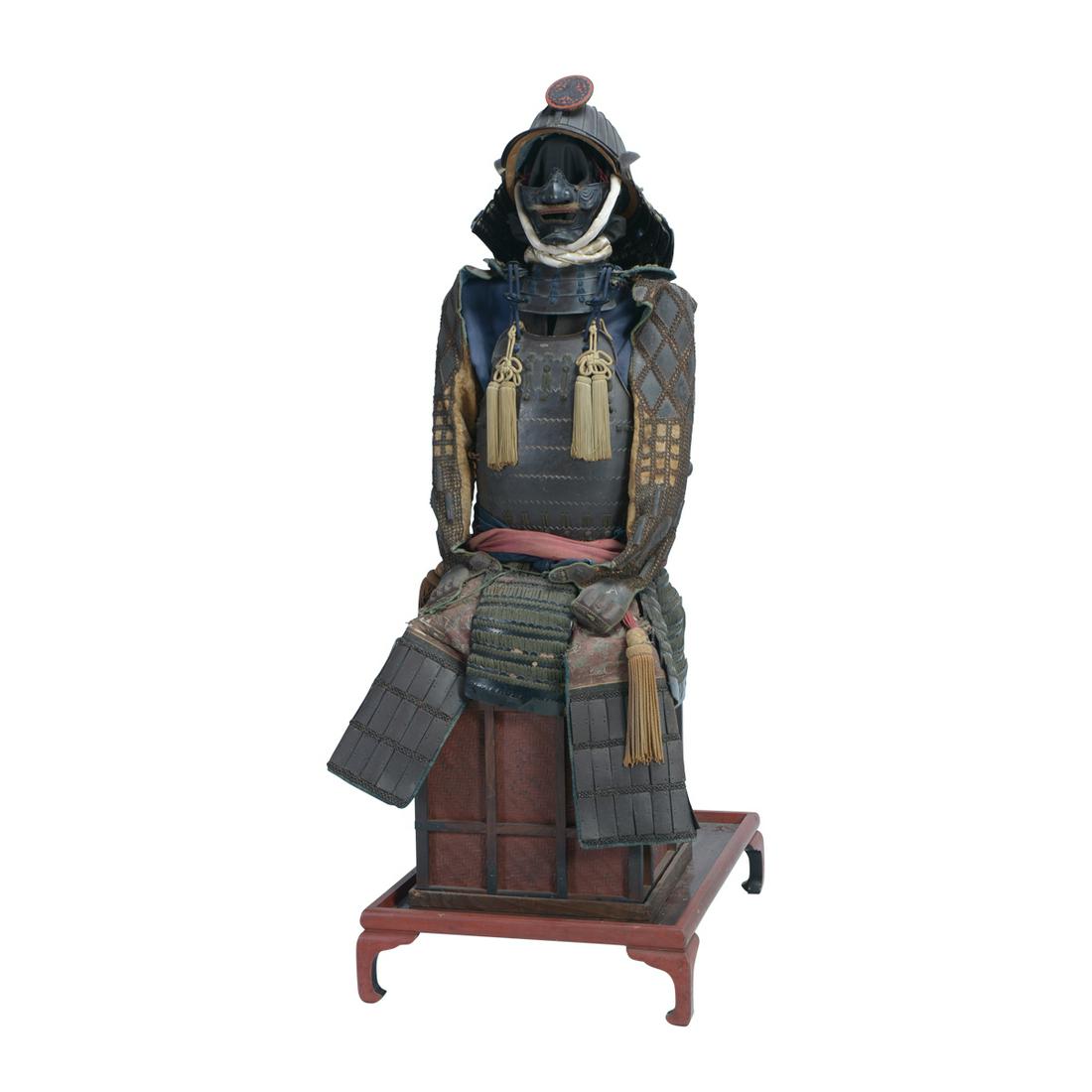 A Suit of Japanese Domaru Armor on Base.: A Suit of Japanese Domaru Armor with Kabuto. The suit lacquered in black and laced in blue and grayish-green, with a twenty-four plate suji-kabuto with a clan crest depicting three kashiwa, black-lacq