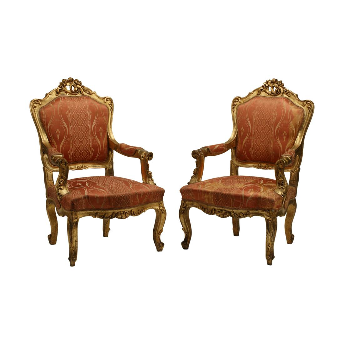 Pair of Louis XV Style Carved Giltwood Armchairs.: Pair of Louis XV Style Carved Giltwood Armchairs. With red silk upholstery. {Approximate dimensions: 44 1/2 high x 28 1/2 wide x 30 inches deep.}. Condition: Front seat rail to one chair is slightly l