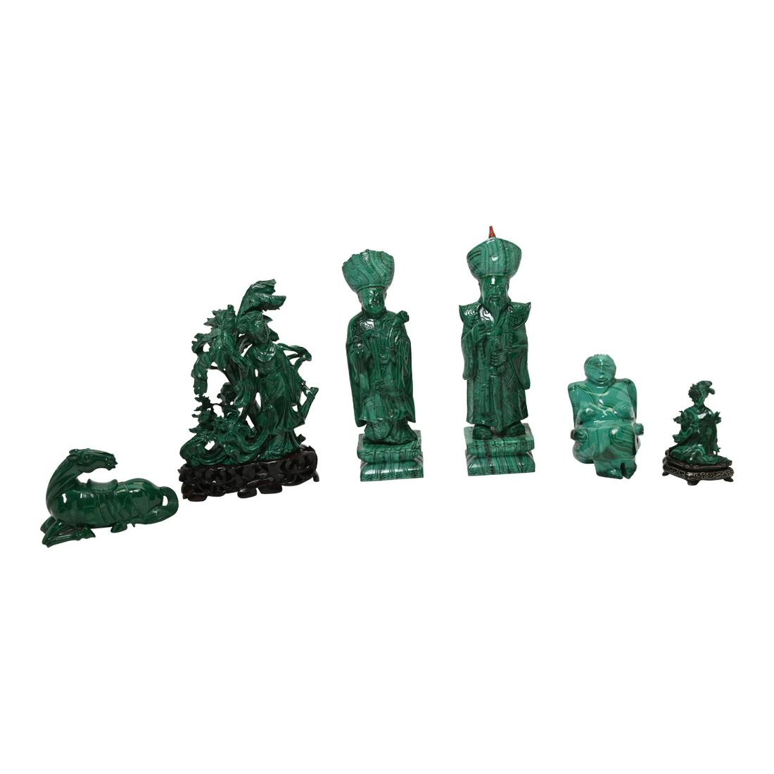 Six Chinese Malachite Carvings.: Six Chinese Malachite Carvings. Including a pair of standing figures holding a sword and jade necklace in long lobe, a female figure wearing a flowing robe in the nature scene, a female figure carved