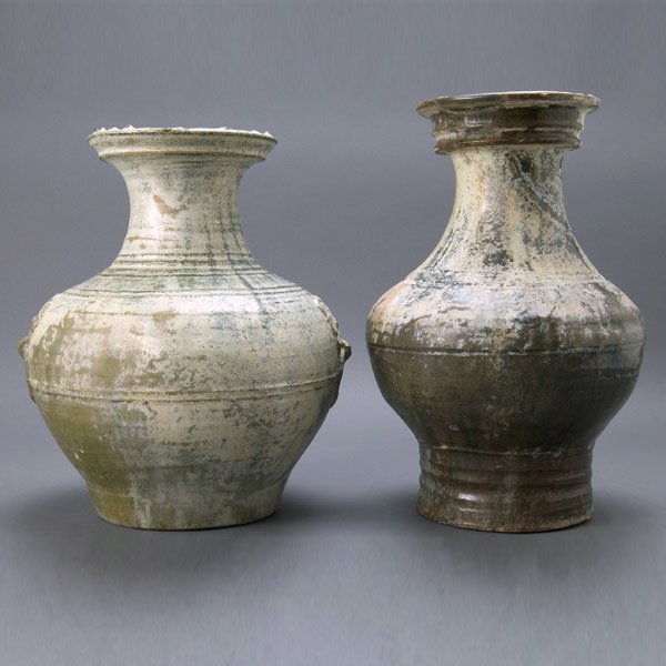 Two Han Metallic Glazed Earthenware Hu: Two Han Metallic Glazed Earthenware Hu Each of baluster form, one with a dark brown glaze, one with a green glaze and a pair of mock lion's head masks. {Height of taller 15 inches (38 cm)}