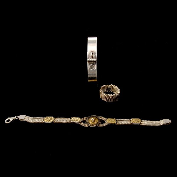 COLLECTION OF STERLING SILVER ITEMS.: COLLECTION OF STERLING SILVER ITEMS. Including a David Yurman sterling silver bracelet; a Tiffany & Co. sterling silver mesh band; together with an enamel, sterling silver, gilt lion bracelet. 44.9 dw