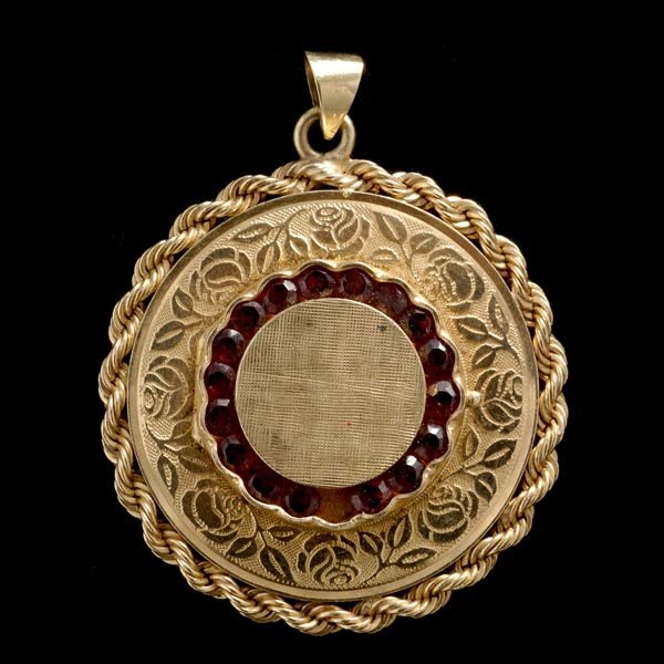 GARNET, 14K YELLOW GOLD LOCKET PENDANT.: GARNET, 14K YELLOW GOLD LOCKET PENDANT. Featuring seventeen round-cut garnets, set in a 14k yellow gold locket pendant measuring approximately 37.00mm in diameter. 10.2 dwts. Note: One stone missing.