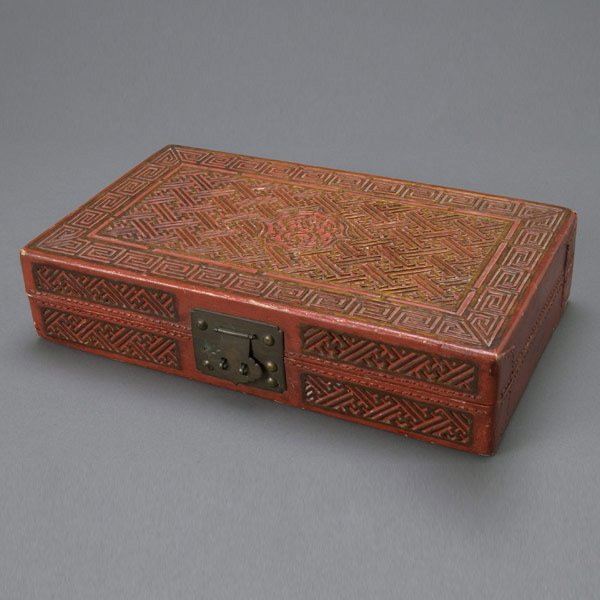 Chinese Rectangular Cinnabar Box, Qing Dynasty: Chinese Carved Rectangular Cinnabar Box, Late Qing Dynasty. Of continuous swastika pattern throughout, central lotus to lid surrounded by key fret border. {Dimensions 3 x 13 1/2 x 8 inches} [Wear, min