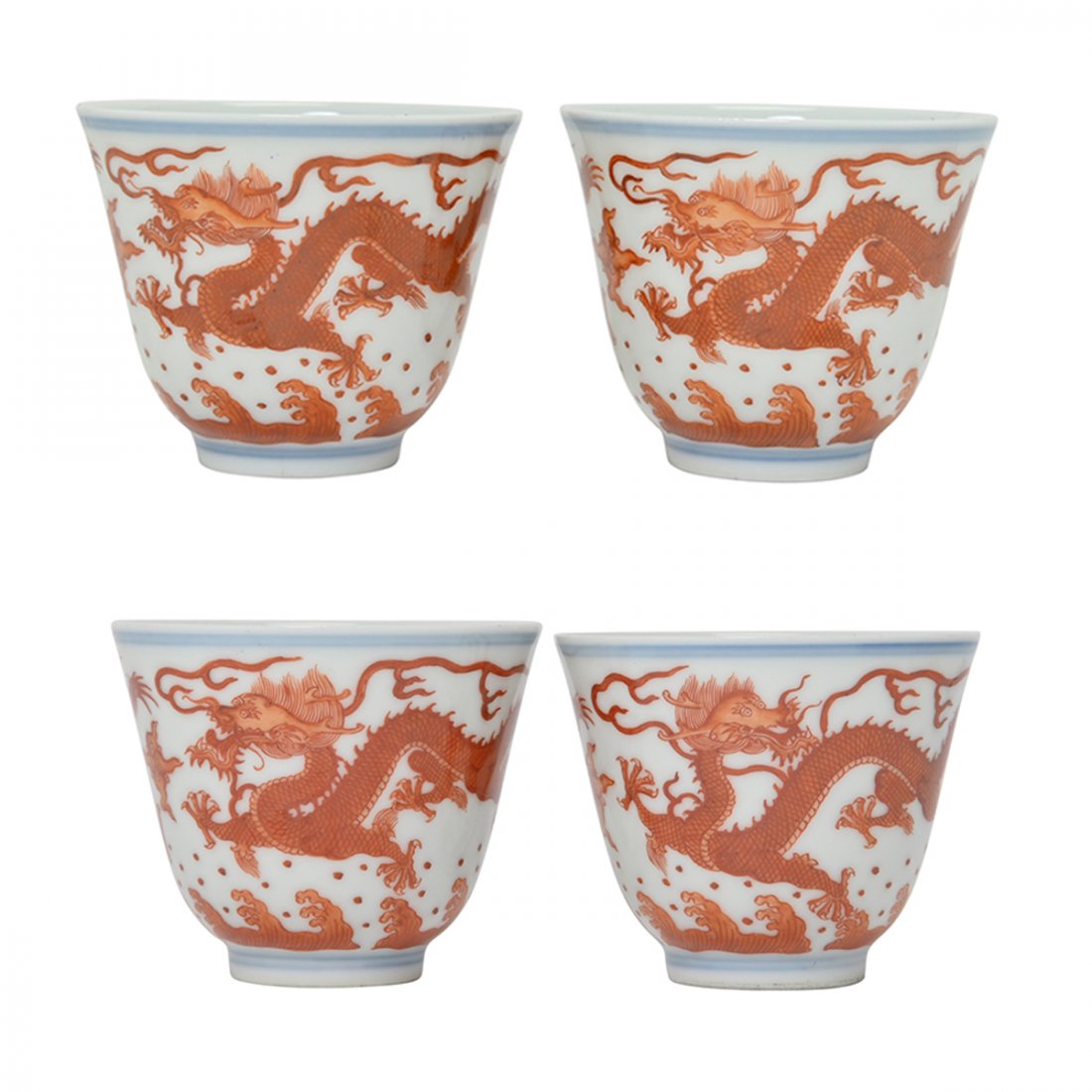 Four Chinese Iron-Red 'Dragon' Cups.: Four Chinese Iron-Red 'Dragon' Cups. Each finely painted in iron-red enamel with two five-clawed dragons above cresting waves, two inscribed with a six-character Xuantong mark and the other pair with 
