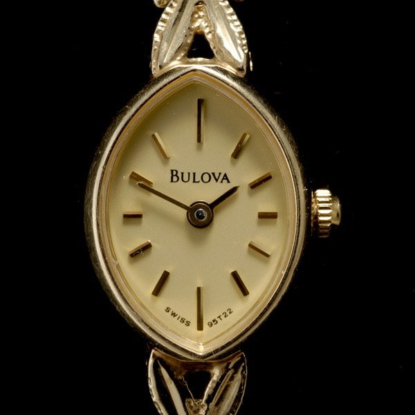 LADIES BULOVA 14K YELLOW GOLD WRISTWATCH.: LADIES BULOVA 14K YELLOW GOLD WRISTWATCH. Dial: Navette, yellow, applied baton hour markers, Bulova. Movement: 4 Jewels, quartz. Case: 14k yellow gold navette shaped snap back, measuring approximately