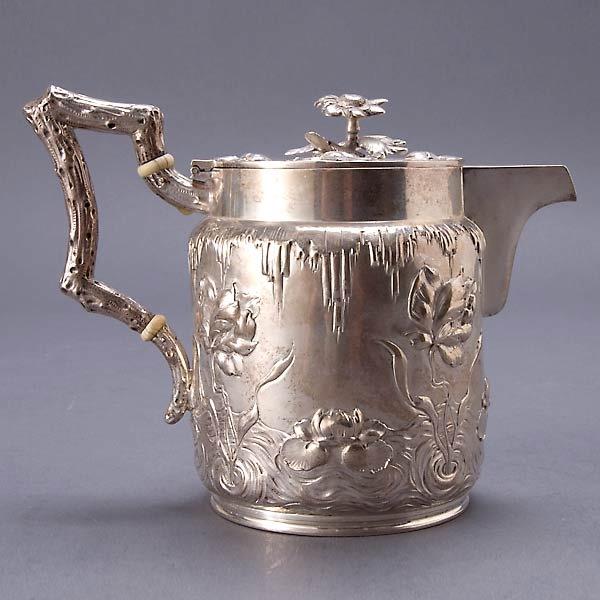 Austrian Art Nouveau 800 Silver Teapot: Austrian Art Nouveau 800 Standard Silver Teapot, the cylindrical form with large flowering iris stems growing out of ground of chased wave indentations, applied branch form handle fitted with ivory in