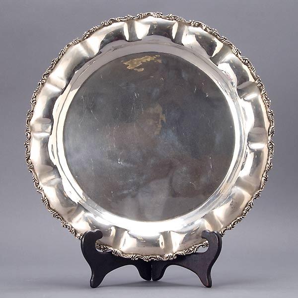 Mexican Sterling Tray: Mexican Sterling Tray, the round form with a dish rim border with repousse pillow form panels and applied scrolling leaf border, "PH" maker's mark, S in cursive script 925 {Total silver weight 41.01 t
