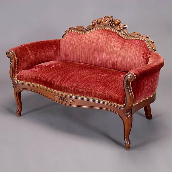 Miniature Louis XV Style Walnut Settee: Miniature Louis XV Style Walnut Settee, Late 19th Century, the curving back with floral crest over twin incurving scroll padded arms, over cabriole legs, with red velvet upholstery {Dimensions 31 1/2 