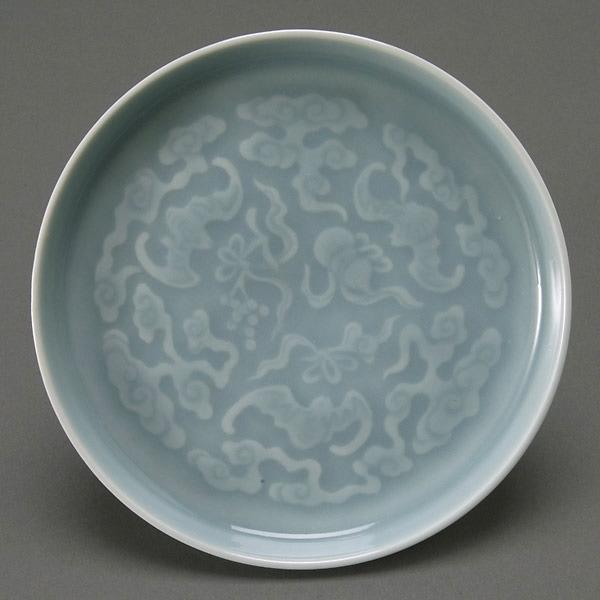 Small Sky-Blue Glazed Porcelain Dish, Qianlong Ma: A Small Sky-Blue Glazed Porcelain Dish, Qianlong Mark, pale monochromatic hue molded with roundel of bats flying among ribbons, ruyi clouds and double gourds, extended rim; exterior of banana leaf and