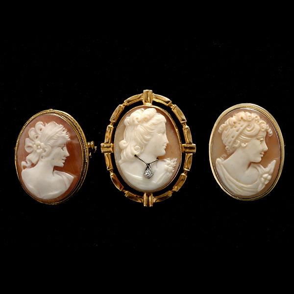 COLLECTION OF THREE BROOCHES.: COLLECTION OF THREE SHELL CAMEO, DIAMOND, 14K, 10K, SILVER BROOCHES. Including one shell cameo, 14k yellow gold pendant brooch; one shell cameo, diamond, 10k yellow gold pendant brooch; together with 