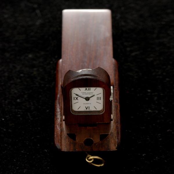 VAN CLEEF & ARPELS PURSE WATCH.: VAN CLEEF & ARPELS STAINLESS STEEL, WOOD PURSE WATCH. Dial: Rectangular, white, black Roman numeral and baton hour markers, black baton hands, Van Cleef and Arpels. Movement: Quartz, 5 Jewels, unadjus