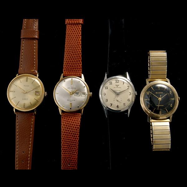 COLLECTION OF FOUR METAL WRISTWATCHES.: COLLECTION OF FOUR METAL WRISTWATCHES. Including one Helbros Automatic, metal, brown leather wristwatch; one Bulova mechanical, metal, adjustable band wristwatch; one Wittnauer Automatic, steel, black