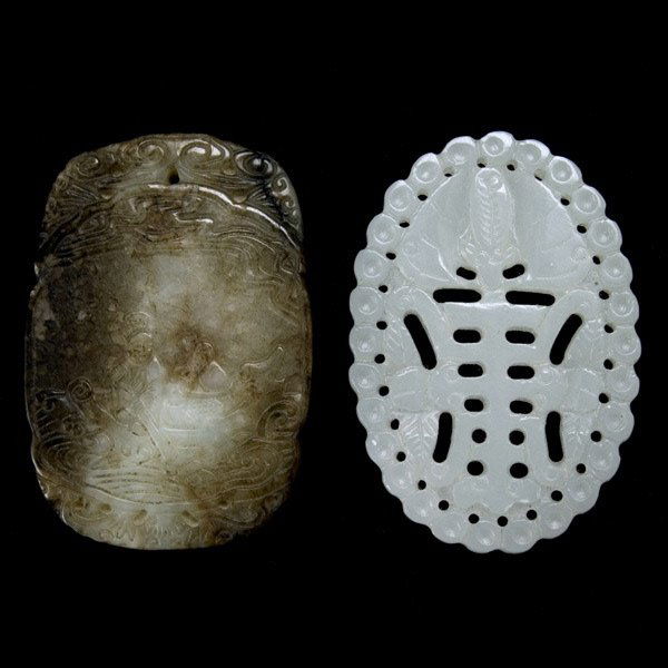 Two Carved Jade Pendants, Republic Period: Two Carved Jade Pendants First of ovoid shape carved in openwork with a large "shou" symbol, insects and a bat surrounded by a border of small circles; second of rounded rectangular shape with a mottl