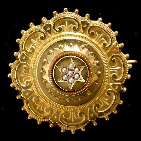 VICTORIAN PEARL, 12K YELLOW GOLD LOCKET PENDANT.: VICTORIAN PEARL, 12K YELLOW GOLD LOCKET PENDANT. The 12k yellow gold mounting, measuring approximately 24.00mm, centers seven half-pearls, completed by a pin stem and catch, the reverse features a loc