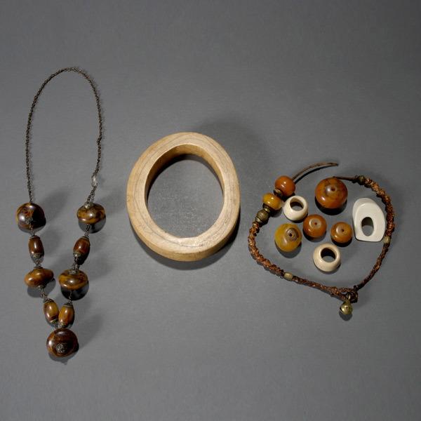 Lot of ivory rings, bangle, & African amber beads: Lot of ivory rings, bangle, & African amber beads.