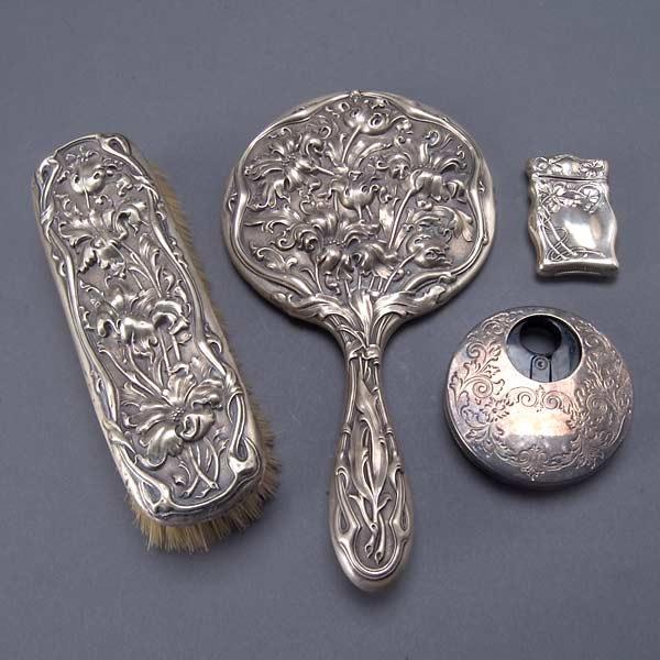 Art Nouveau Sterling Mounted Hand Mirror and Brush: Art Nouveau Sterling Mounted Hand Mirror and Brush; together with a sterling match safe and plated cigar cutter (4) {Height of mirror 9 1/4 inches}