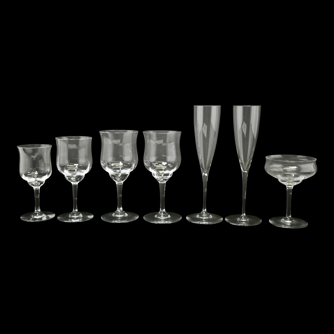 78 Baccarat Crystal Capri Pattern Stems.: 89 Baccarat Crystal Capri and Dom Perignon Pattern Stems. A drinks service comprising: 31 champagne flutes, Dom Perignon pattern, 9 1/2" H. 15 champagne coupes, Capri Optic, 5 1/4" H. 27 water glasses