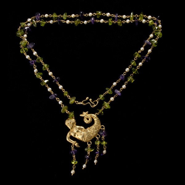 CELIA HARMS STERLING SILVER GILT NECKLACE: CELIA HARMS, CULTURED PEARL, AMETHYST, PERIDOT, STERLING SILVER GILT NECKLACE. Featuring a mermaid of gilted sterling silver, suspended and tasseled with numerous tumbled amethyst and peridot beads, i