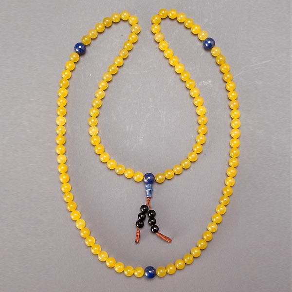 A Prayer's Necklace: A Prayer's Necklace, composed of yellow crystal and lapis beads with central tassel strung with black beads {Approximate length 45 1/2 inches}