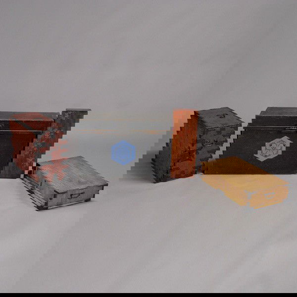 Four Japanese Boxes and a Small Chest: Four Japanese Boxes and a Small Chest, of various sizes, colors and decorations including a blue floral crest to the lantern box and a mother-of-pearl inlaid poem box; most with iron mounts and locks