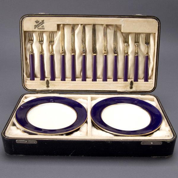 6 Minton Fruit Plates & 12 Sterling Forks & Knives: Cased Set of Six Minton England Porcelain Fruit Plates and Twelve Sterling Forks and Knives with Blue Composition Handles {Diameter of plates 6 1/4 inches} [One plate with hairline crack and crazing]